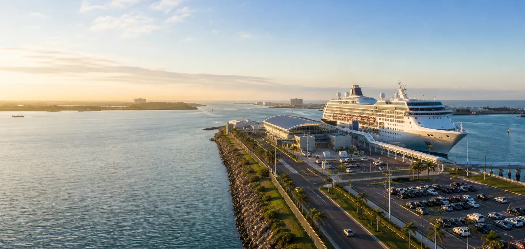 Cruise terminal approach road, parking area, harbor, and ship at sunrise